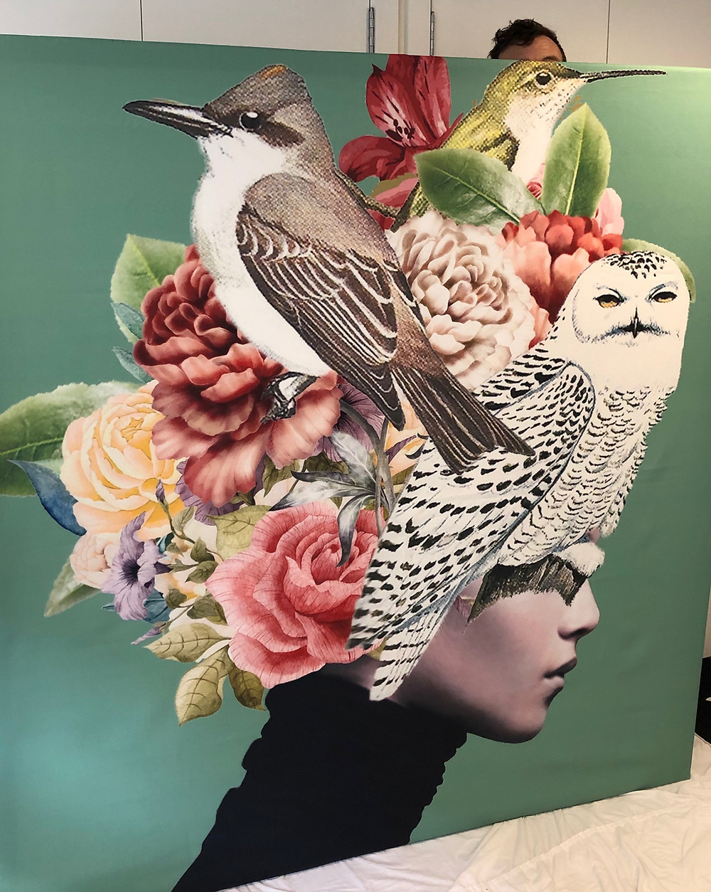 Artwork of lady with flowers and birds in hair on green background