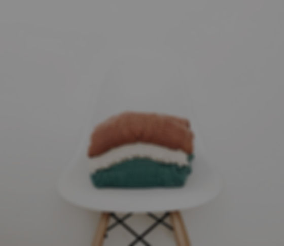 three knit piles of clothes on white chair_edited_edited.jpg