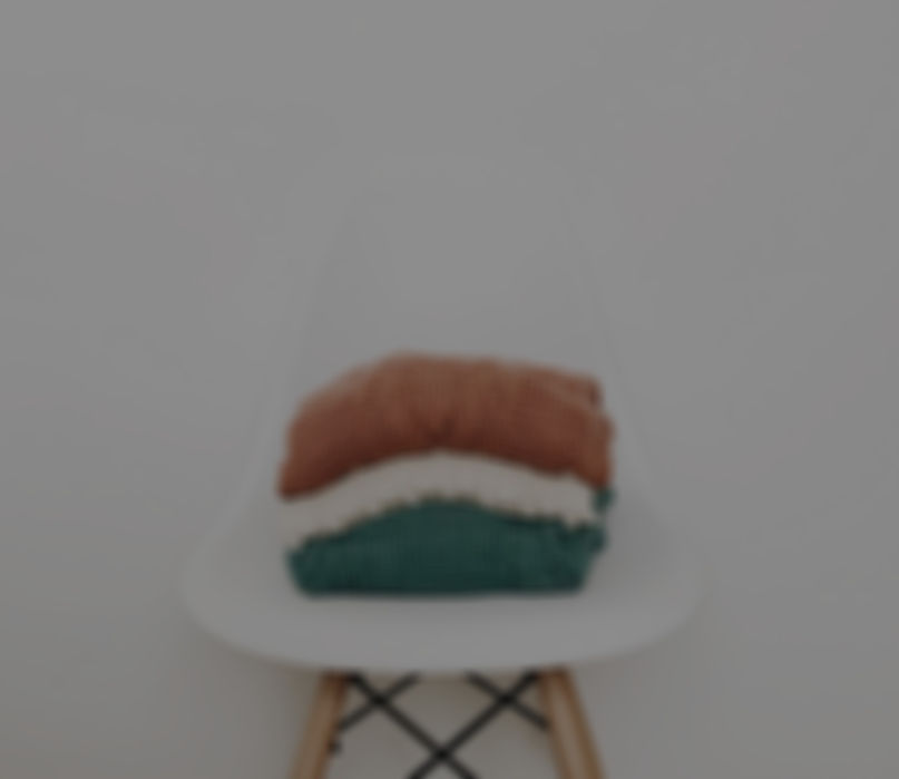 three knit piles of clothes on white chair_edited_edited.jpg