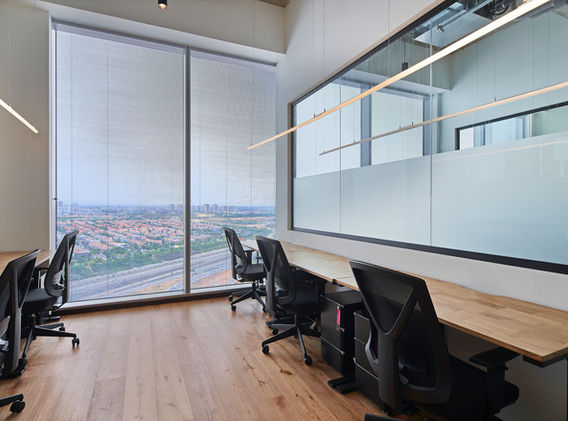 Private office with multiple workstations and city view at SOK Rishon LeZion