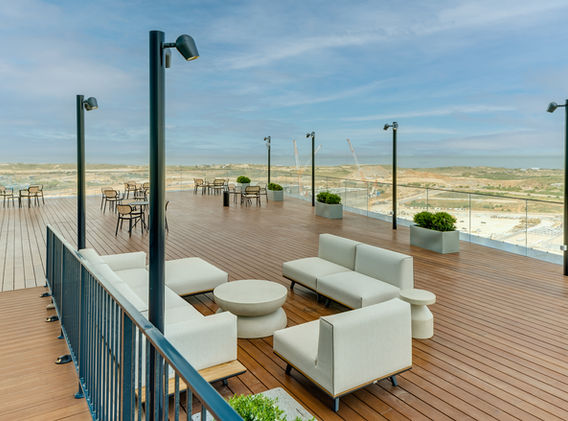 Spacious rooftop terrace with lounge seating and sea view at SOK Rishon LeZion