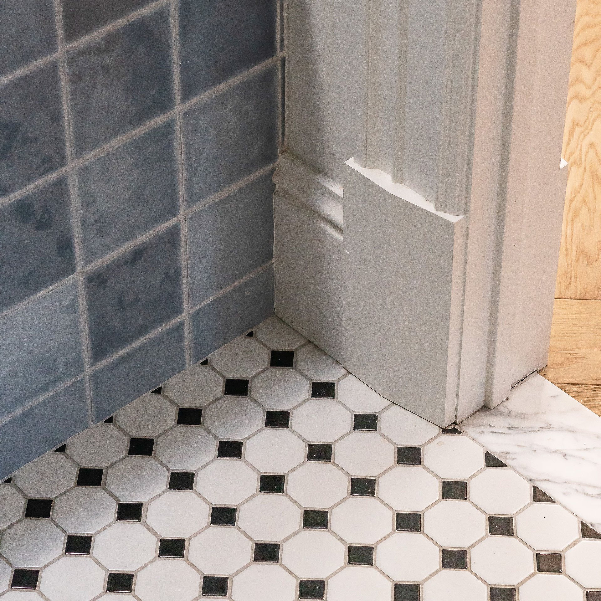 Junctions of the wall tile, floor tile, restored baseboards and door frames