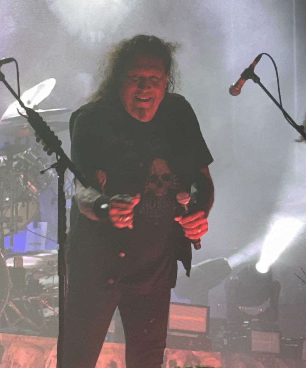 Chuck Billy of Testament trying to hit me with a guitar pick…which he did.