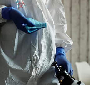 Biohazard cleanup technician in PPE for crime scene cleanup services