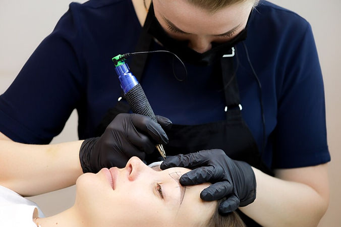 permanent-makeup-artist-performs-tattoo-eyebrows-according-markings-drawn-earlier_320071-7