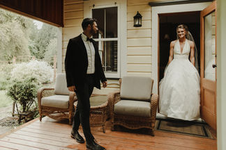 A+C's west coast island wedding at Bilston Creek Farm was a stunning celebration that embraced the moody atmosphere of the surroundings in all the right ways. With dramatic rain and a lush forest as their backdrop, the couple took full advantage of the picturesque property, resulting in breathtaking photos that captured the essence of their special day. Their outdoor ceremony was held beneath a magnificent tree, creating a magical setting that was both intimate and enchanting. The reception, located in The Barn, was designed with simplicity and elegance in mind, featuring rustic wooden tables, stylish black metal chairs, and beautiful fresh evergreens, all working together to enhance the natural beauty of the venue.