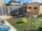 After photo of backyard with a new wooden garden shed and patio.