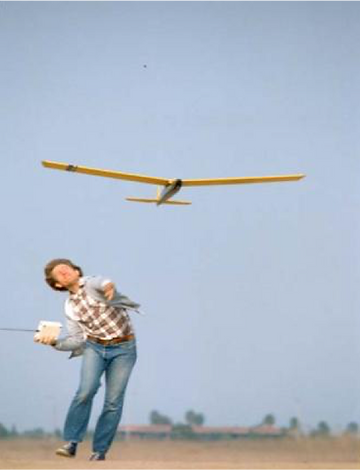 Man throwing glider in air