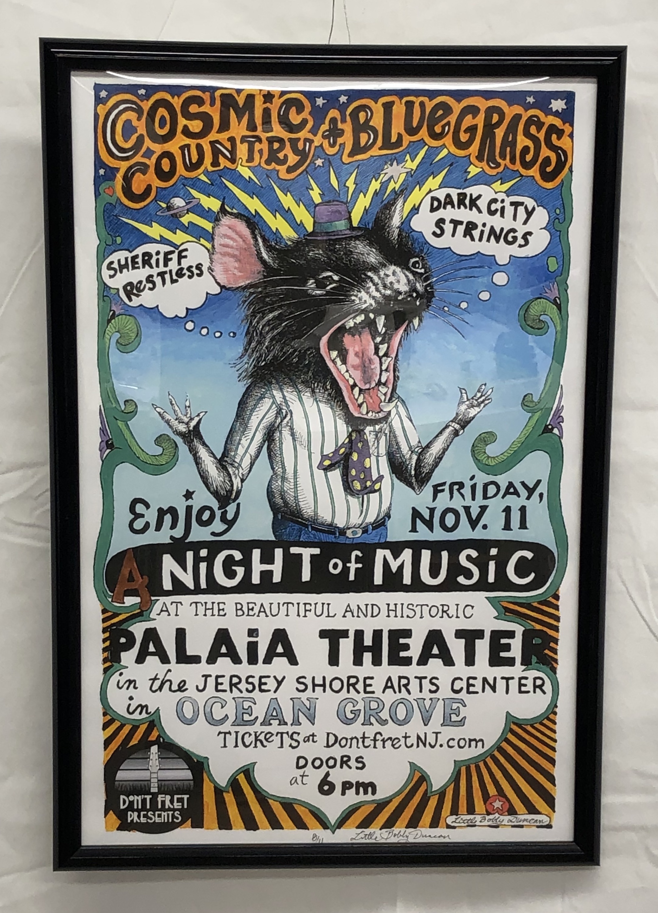 Color framed signed concert poster