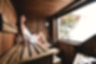 Woman relaxing inside a sauna.