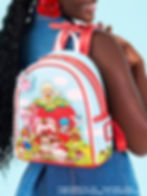 A close-up of a kids' backpack on a girl's shoulder.