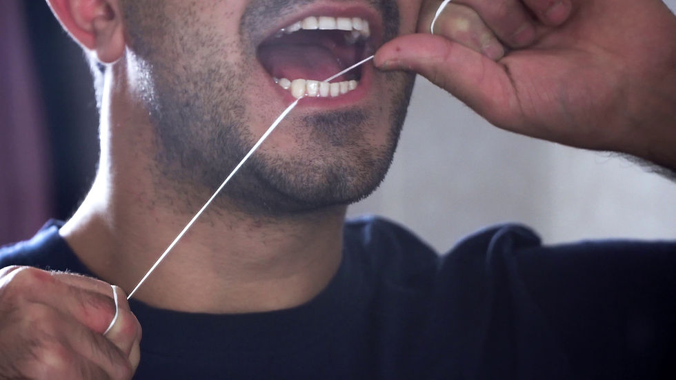 Man flossing his teeth