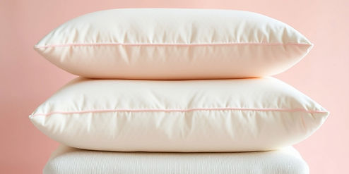 close up of memory foam pillows stack on top of each of on a light pink backgorund_edited_