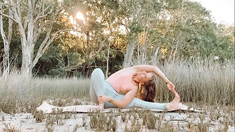 woman doing yoga with sunset