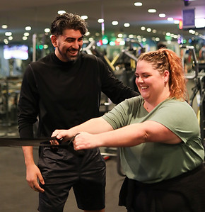 Coach Frank guides a client through a workout at the High Voltage gym facility.