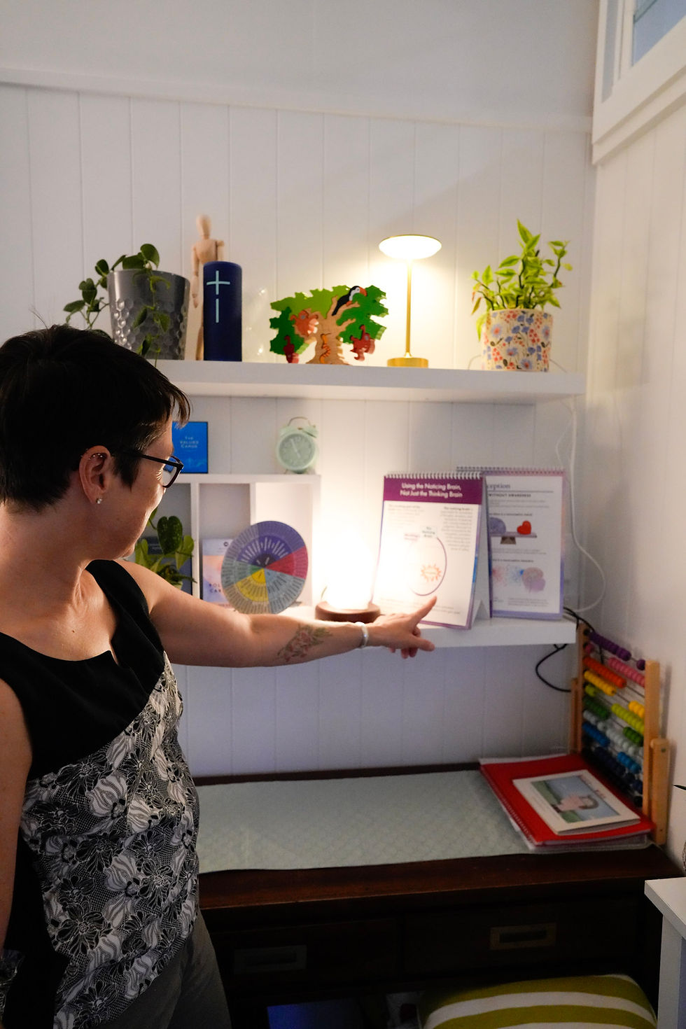Woman pointing to mental health tools for therapy in Brisbane.