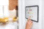 Controlling home with a digital touch screen panel installed on the wall in the living roo