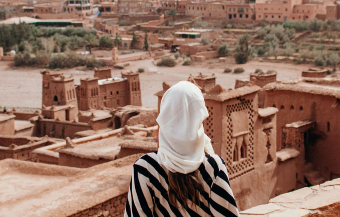 Woman fascinated by mud architecture in Morocco
