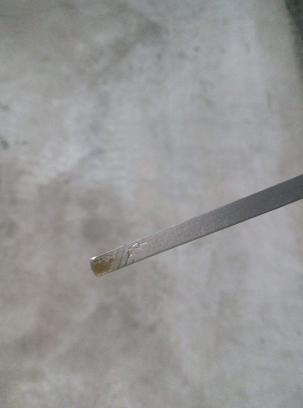 Lawn mower engine oil dipstick showing a low level of oil