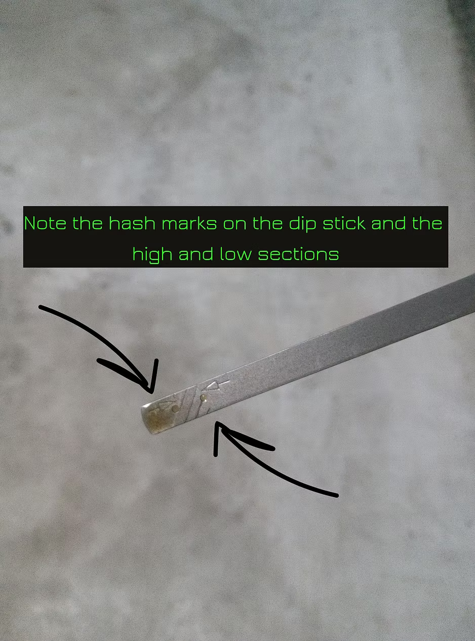 close up of lawn mower engine oil dipstick