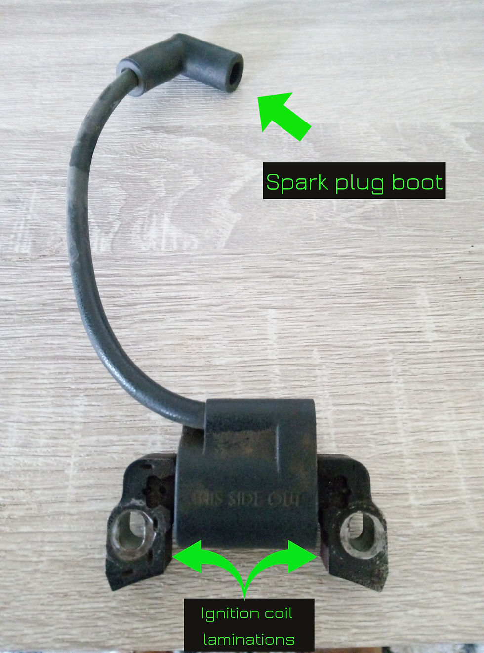 Lawn mower ignition coil with spark plug wire labelled
