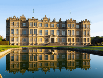 Longleat House, the magnificent Elizabethan stately home in Wiltshire, reflected in the formal gardens.