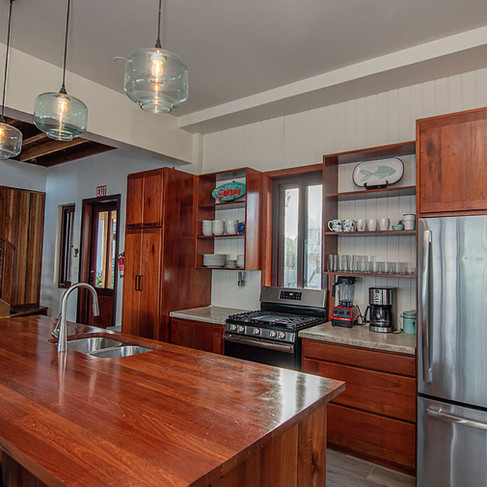 Kitchen complete with pots, pans dishes and spices.