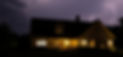 House at night with the lights on and a stormy sky__edited.jpg