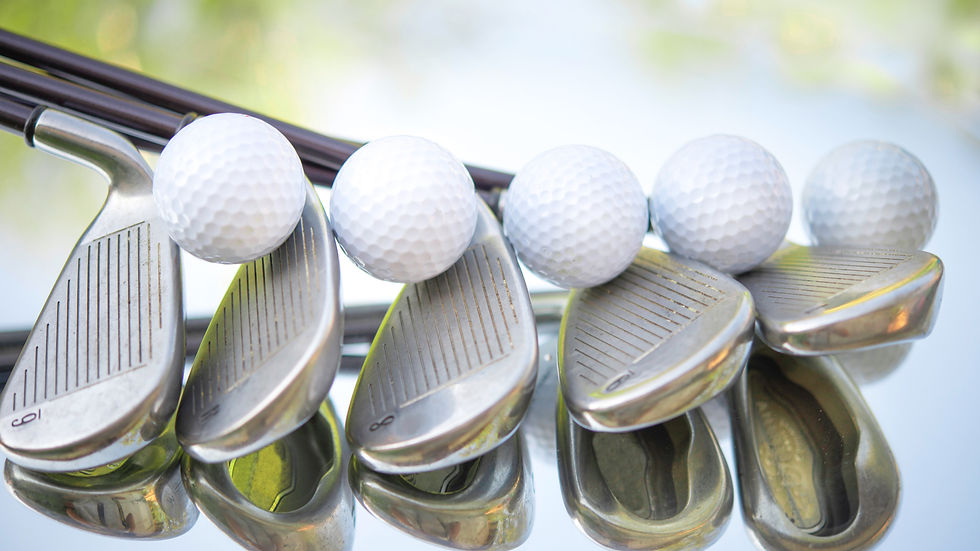 Golf balls stacked on irons