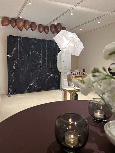 Event setup featuring a luxury photo booth and flower wall backdrop in Metro Detroit