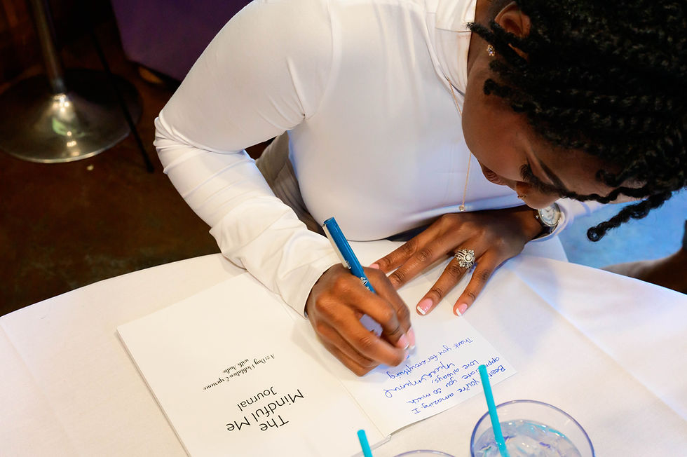 Woman writing a personal note in a book.