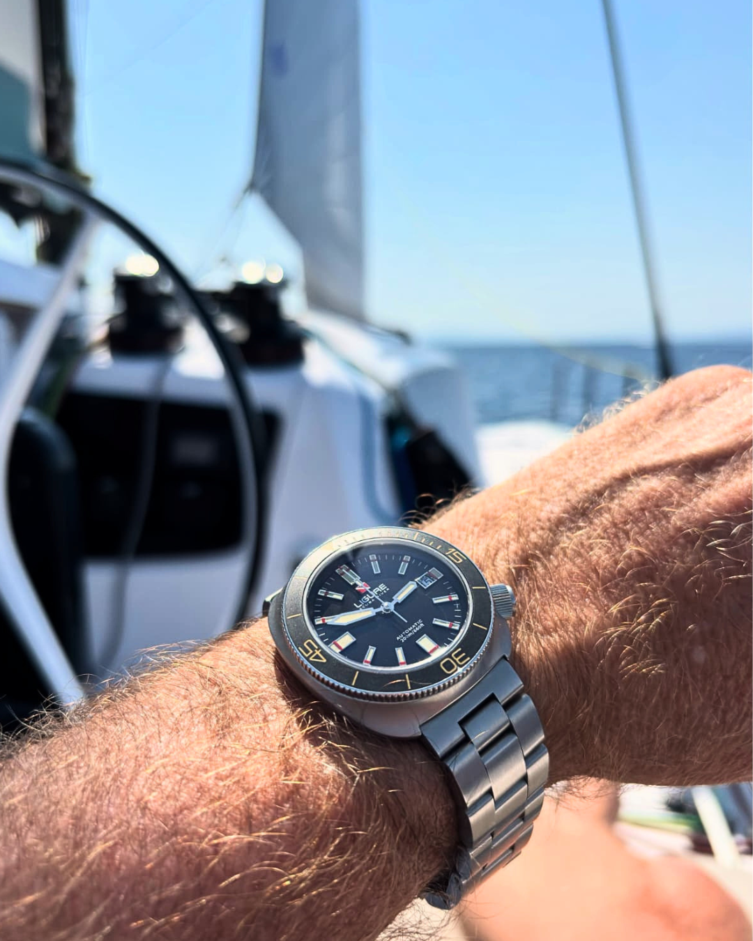 ligure watch in hand of a person in a boat