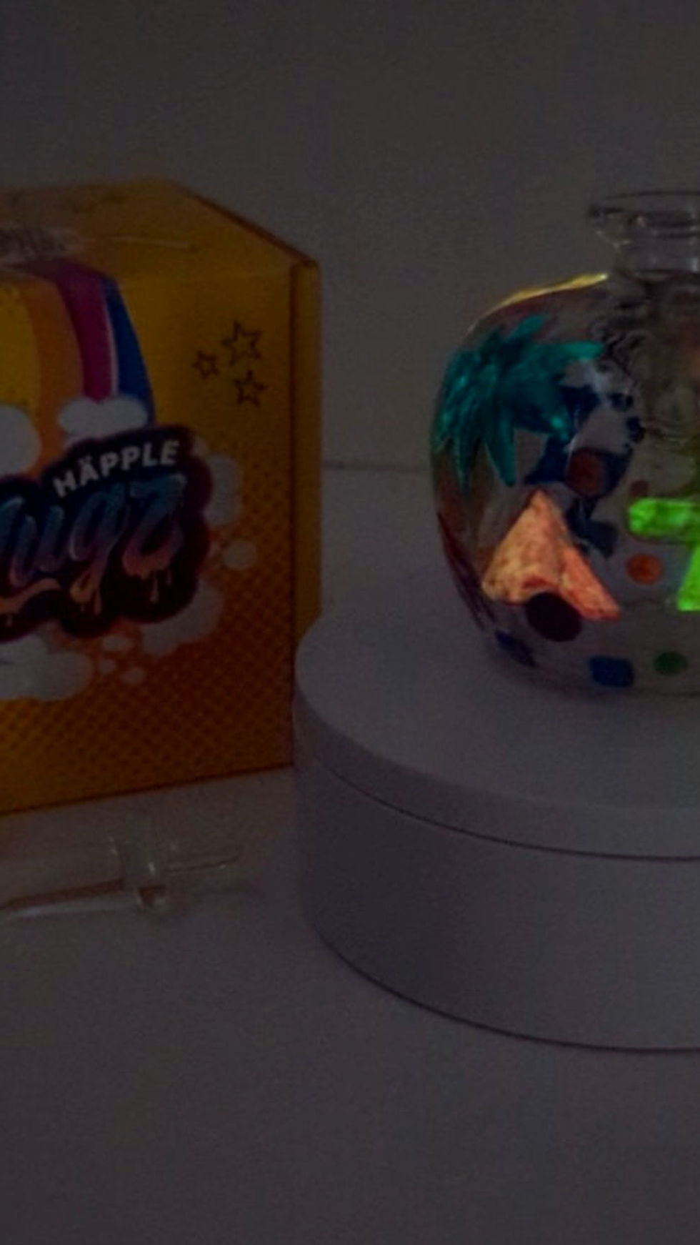 Thumbnail: side profile view of the glow in the dark feature on the Neon 90's Hand-painted Happle Hash Pipe