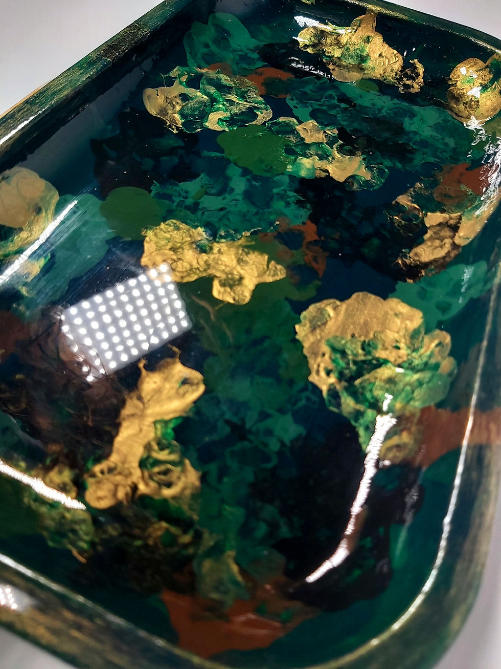 Thumbnail: Close up view of the rich greens, golds and browns swirling together on the "Capricorn" Medium Rolling herb tray. 