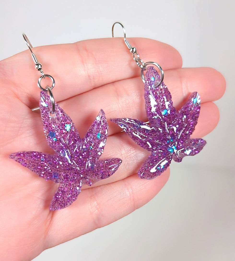 Thumbnail: Large Sizing of  "Purple Haze" Glitter weed leaf earrings sativa against hand