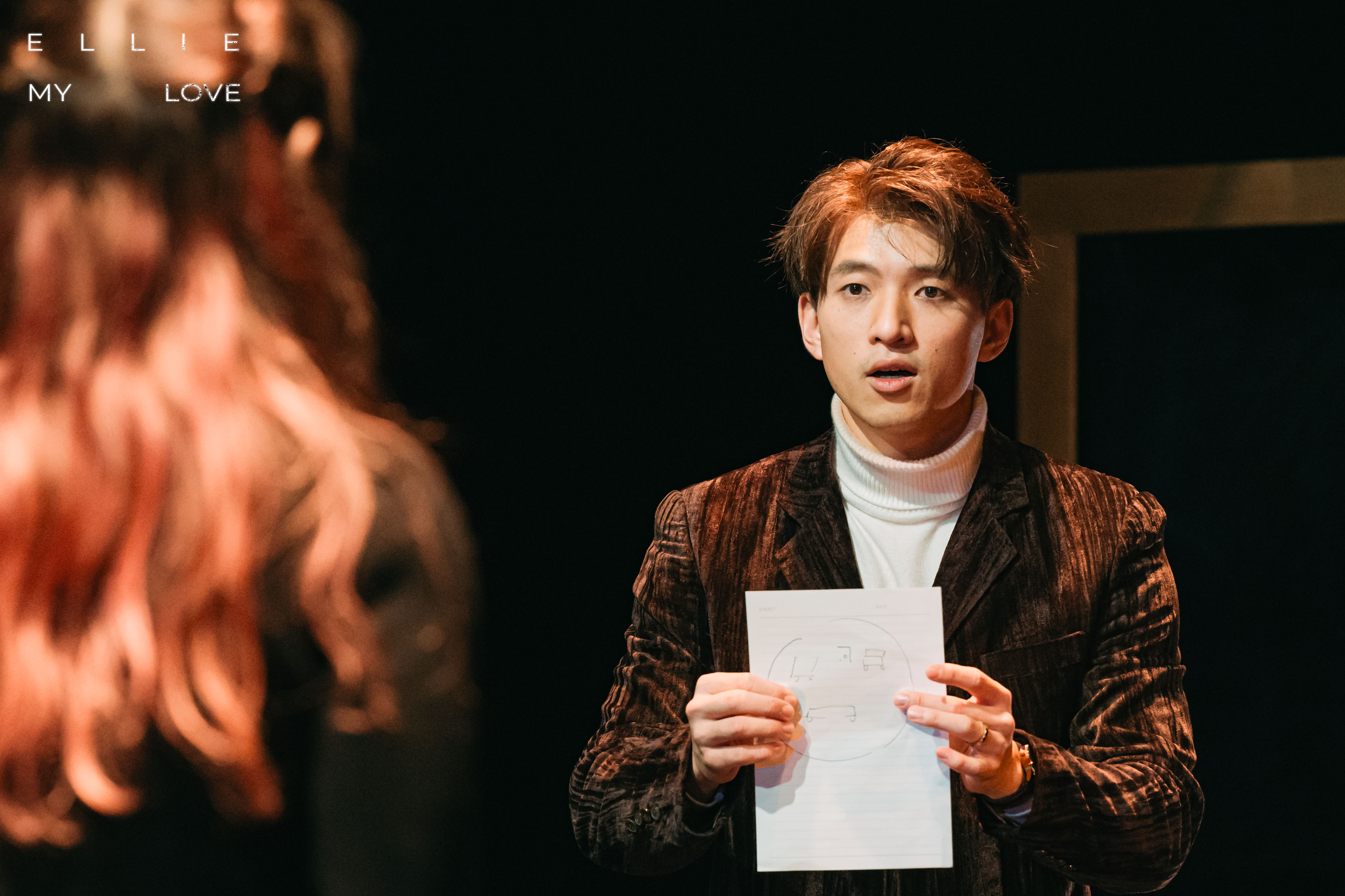 Terrence Leung in a scene from Ellie, My Love, holding a drawing
