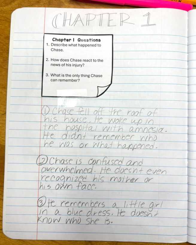 Notebook page titled "Chapter 1" with questions and answers about Chase, who has amnesia after an accident. Text is handwritten in pencil.