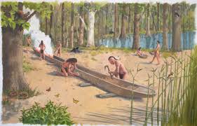 Native Americans digging a canoe