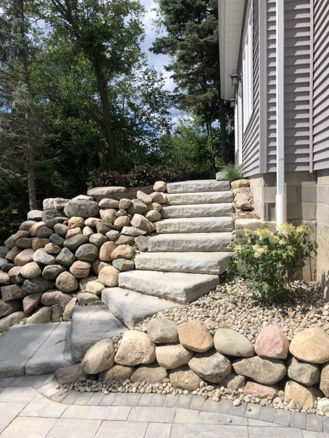 Stone step walkway, boulder wall  and landscaping in the Fenton, Michigan and surrounding area.