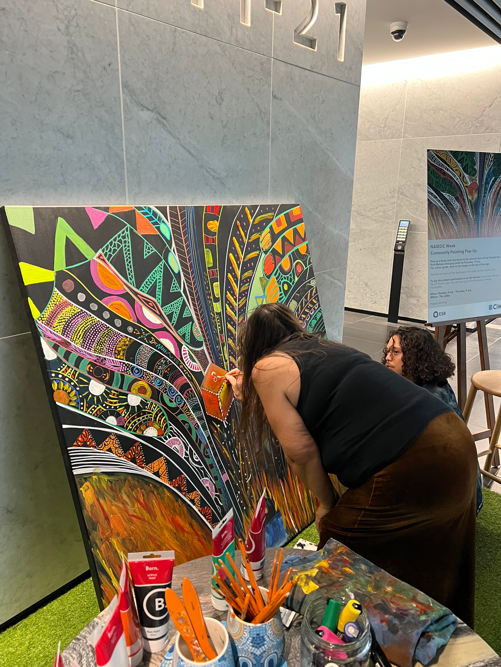 Collaborative NAIDOC mural at CBRE North Sydney, finished by an Indigenous artist.