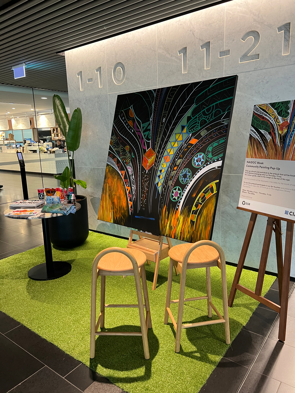Collaborative NAIDOC mural at CBRE North Sydney, finished by an Indigenous artist.