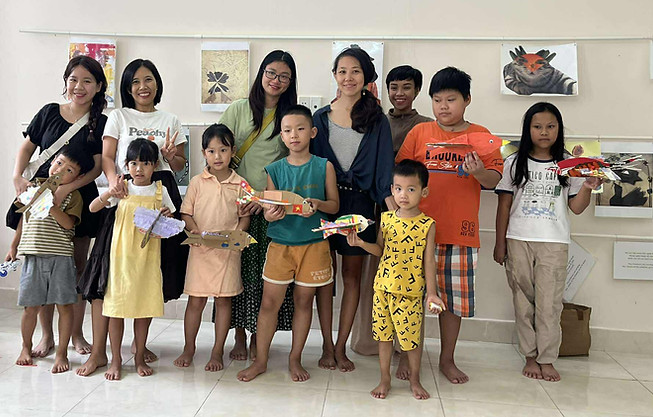 Child choosing artwork from the Art Lending Program at B&P Art For Children in Da Nang