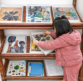 Child borrowing artwork from the Art Lending Library