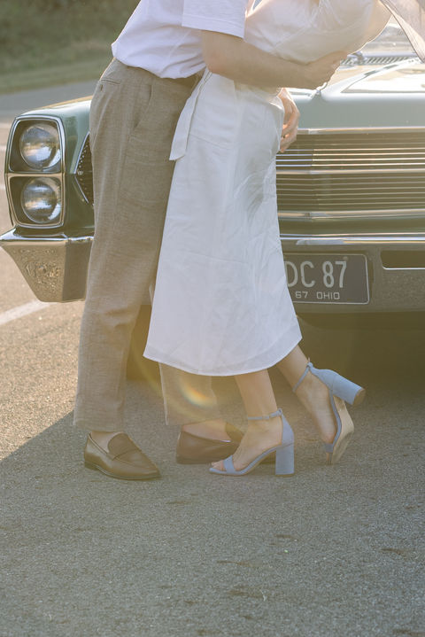 Couple standing near a vintage car with license plate DC 87 in Ohio.