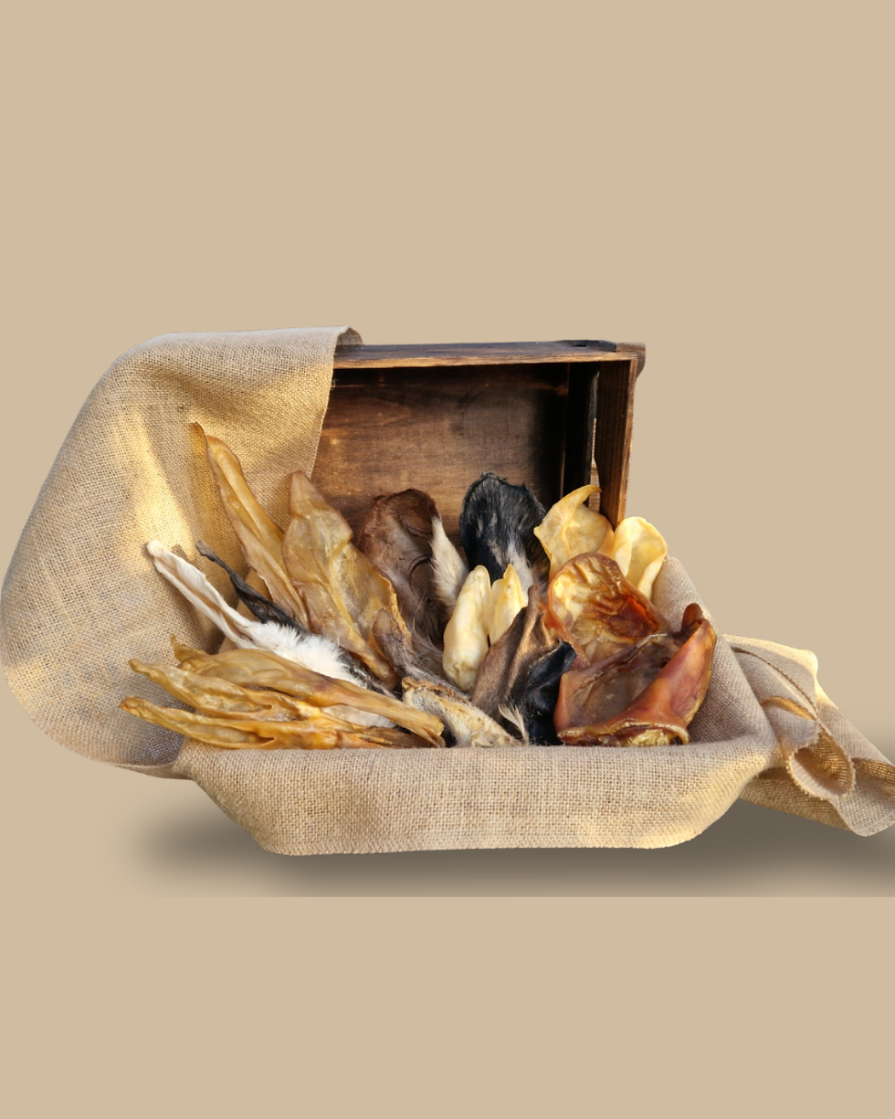 A selection of natural dog treats arranged in a basket as part of Alpha Dog Supplies Chearful Bundle