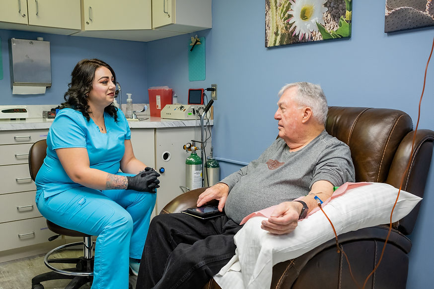 Nurse administering an IV to an elderly man