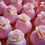 Thumbnail: Angled view of pink magnolia bath bombs with white and blush faux petals on a soft background