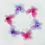 Thumbnail: Circle of pink and purple butterflies made of mesh fabric and wire on a white background