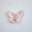 Thumbnail: faintly pink pigmented clear iridescent butterfly charm