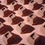 Thumbnail: mini chocolate bath bombs shaped like cubes of chocolate on a plain brown background